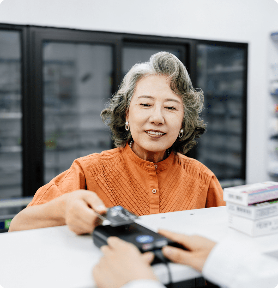 Woman paying with card at pharmacy